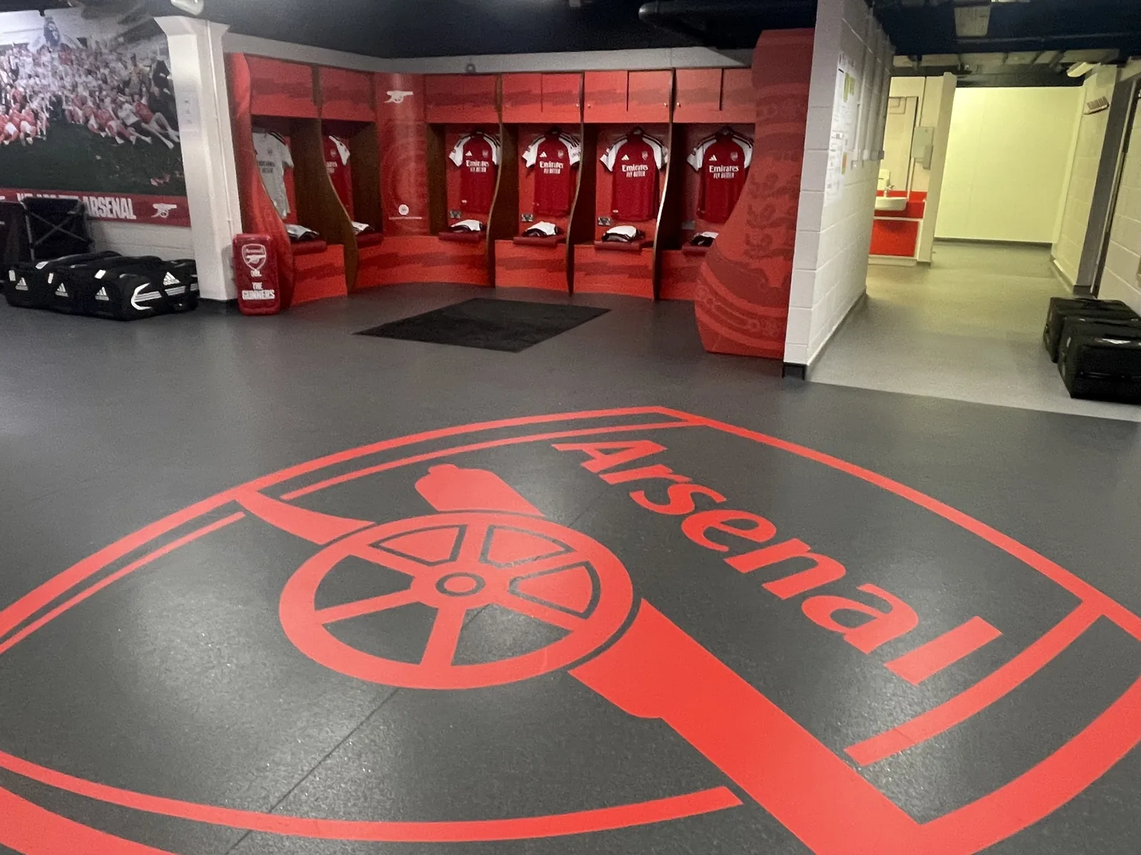 Red wall graphics wrapped around the lockers and a large crest graphic on the dressing room floor