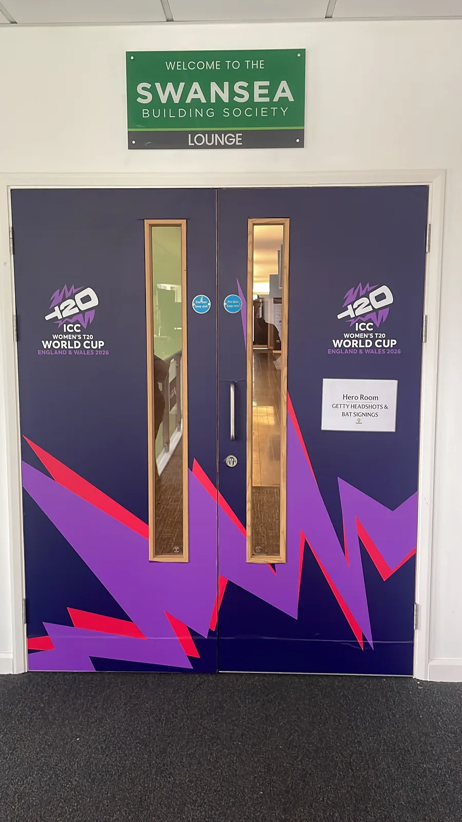 Full-height vinyl door wrap cut precisely around vision panels and door furniture