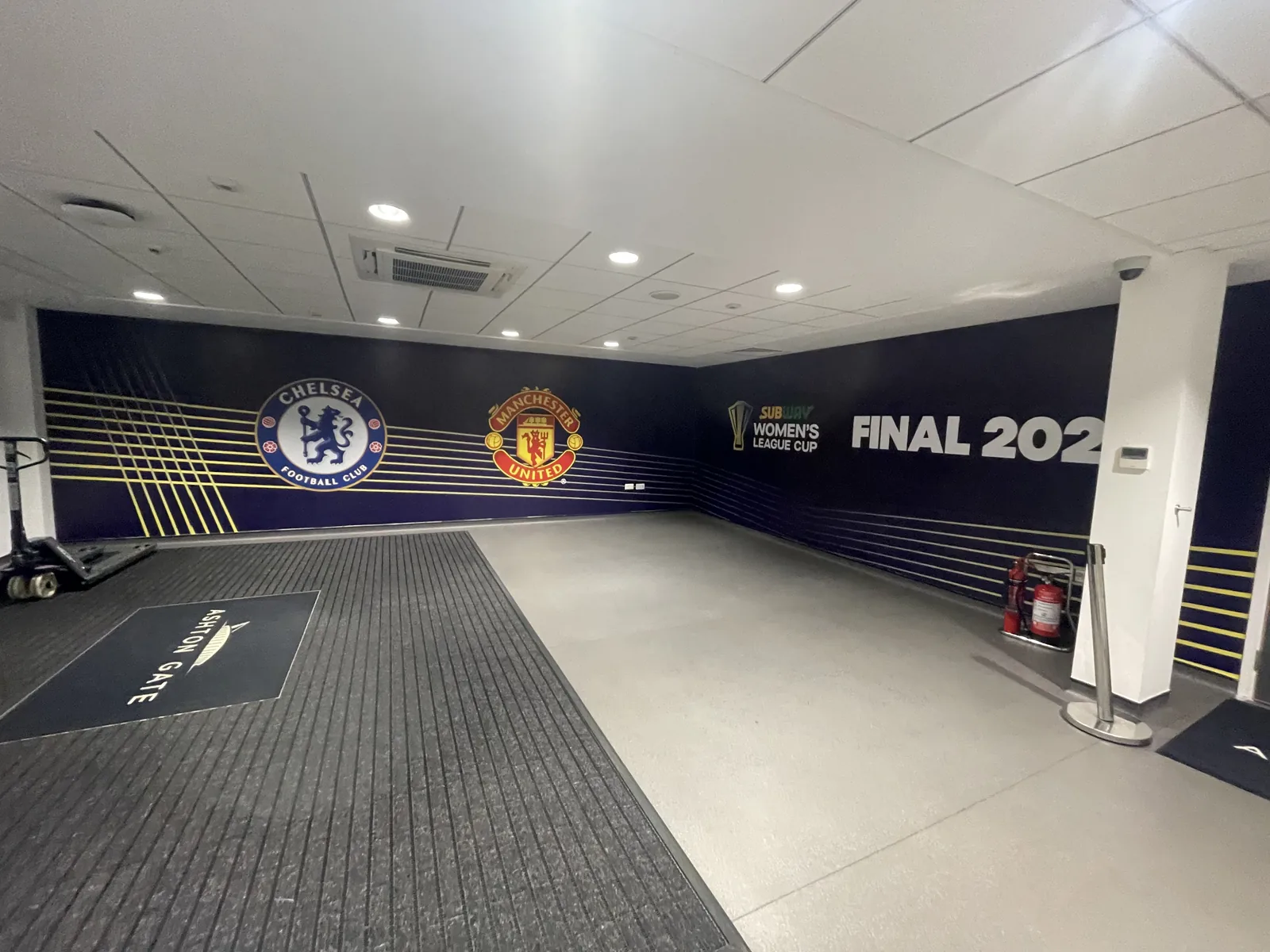 Printed wall vinyl running the length of a players' tunnel